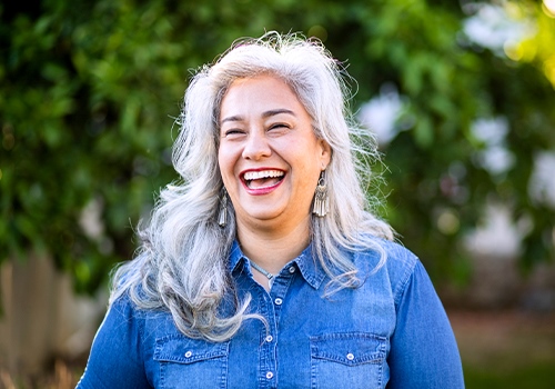 Woman wearing hearing aids and laughing