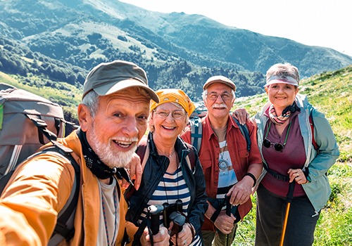 Group of four, wearing Beltone hearing aids and hiking