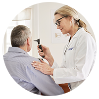 Beltone Skoric doctor examining patient for a hearing test