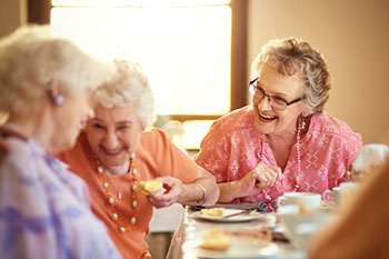 Group of friends with hearing aids laughing together