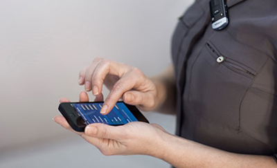 Woman customizing her hearing aid settlings with her phone
