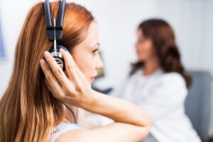 young woman getting hearing test